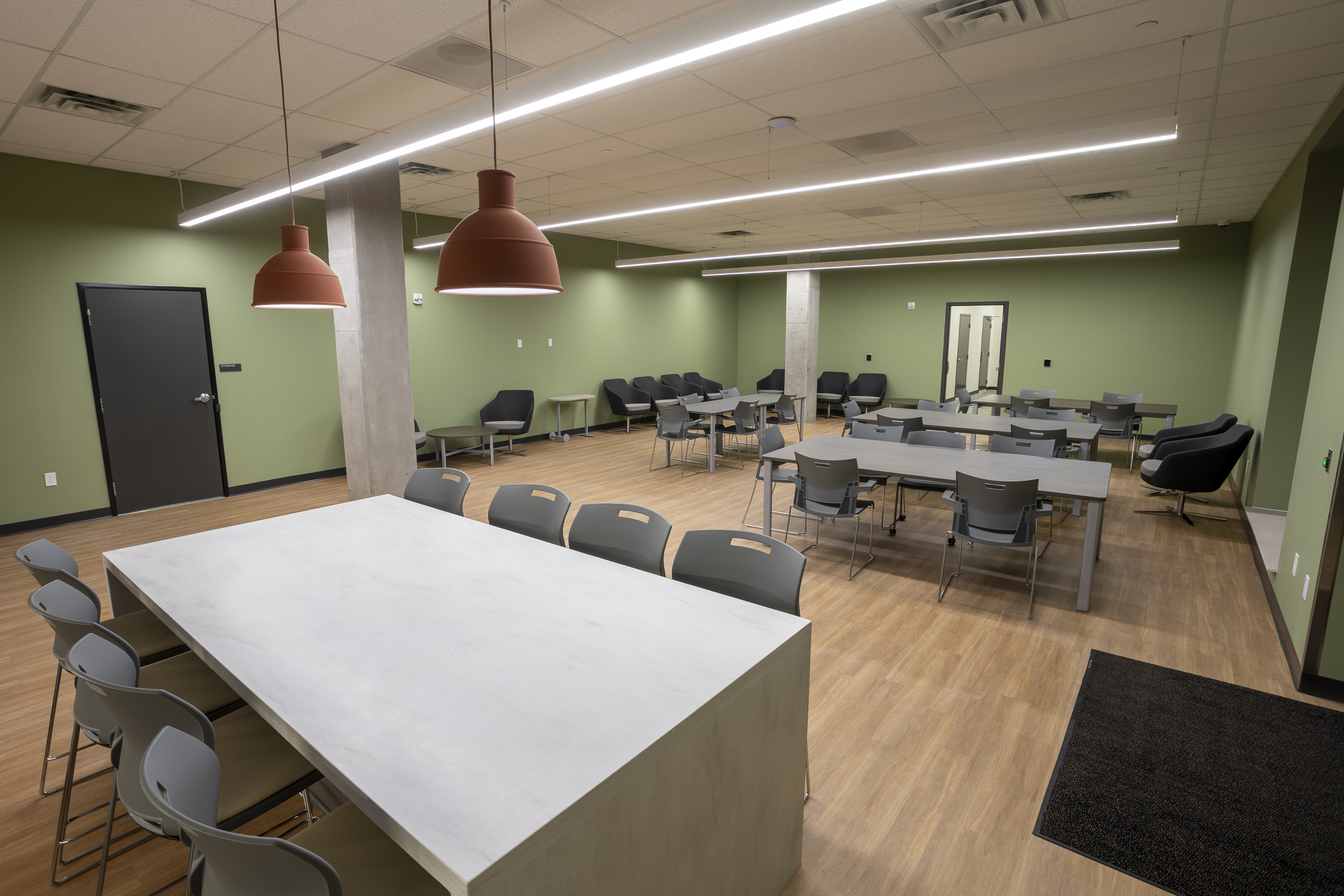 First floor community room complete with plenty of chairs and tables and kitchenette