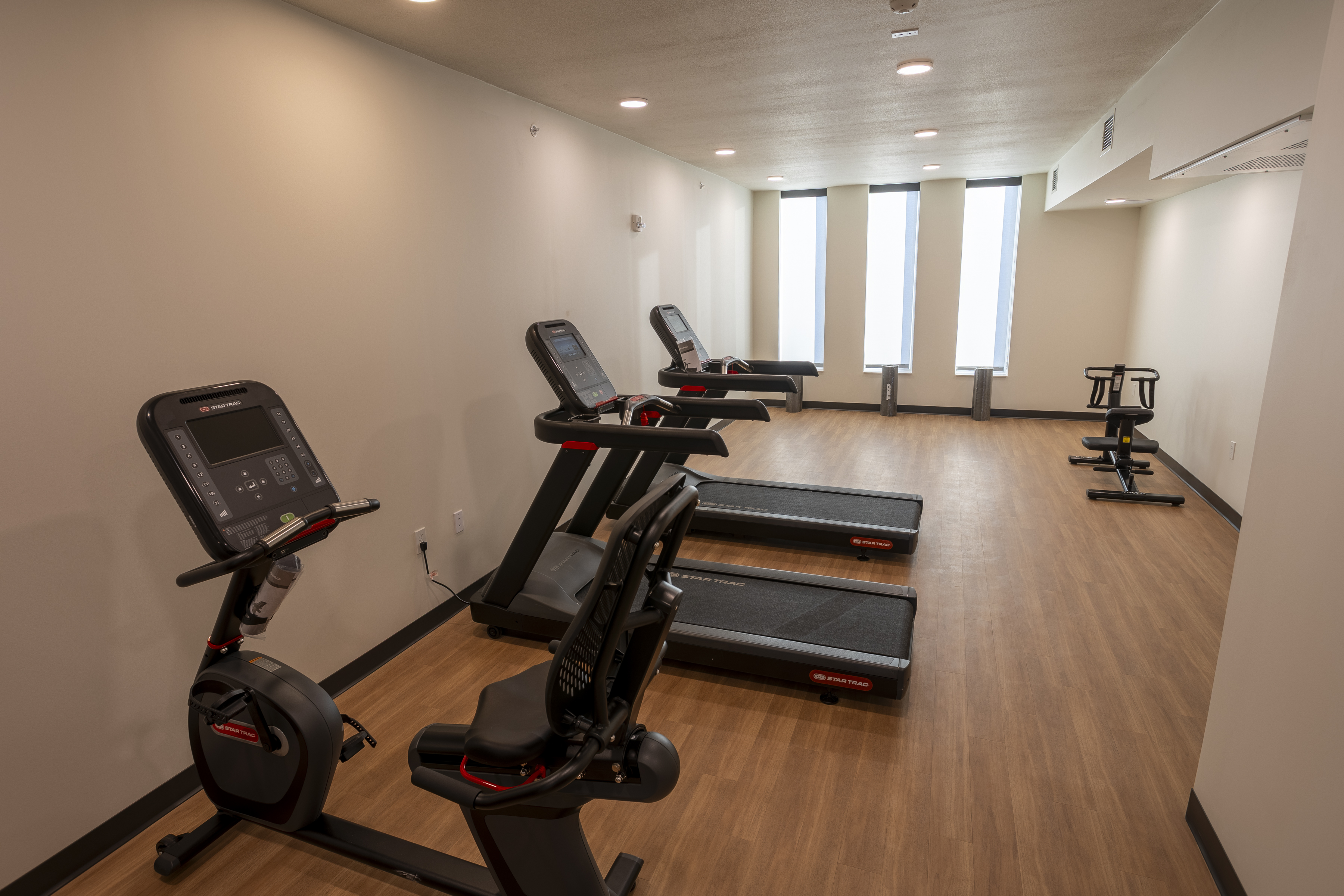 Spacious fitness room with treadmills and stationary bike