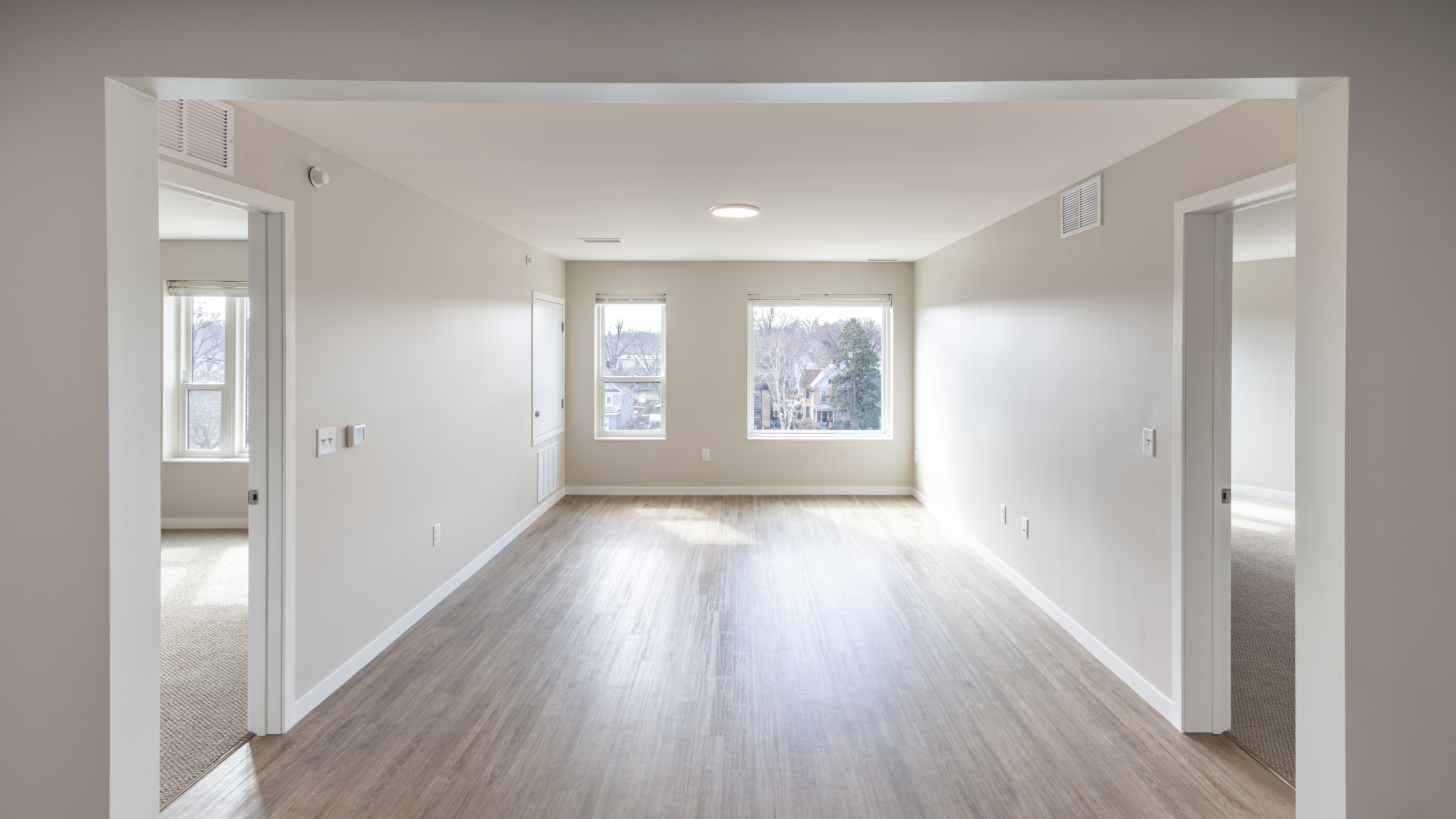 Spacious living room leading into bedrooms and bathrooms