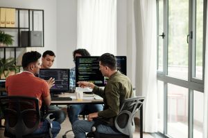 Four people sitting at computers 