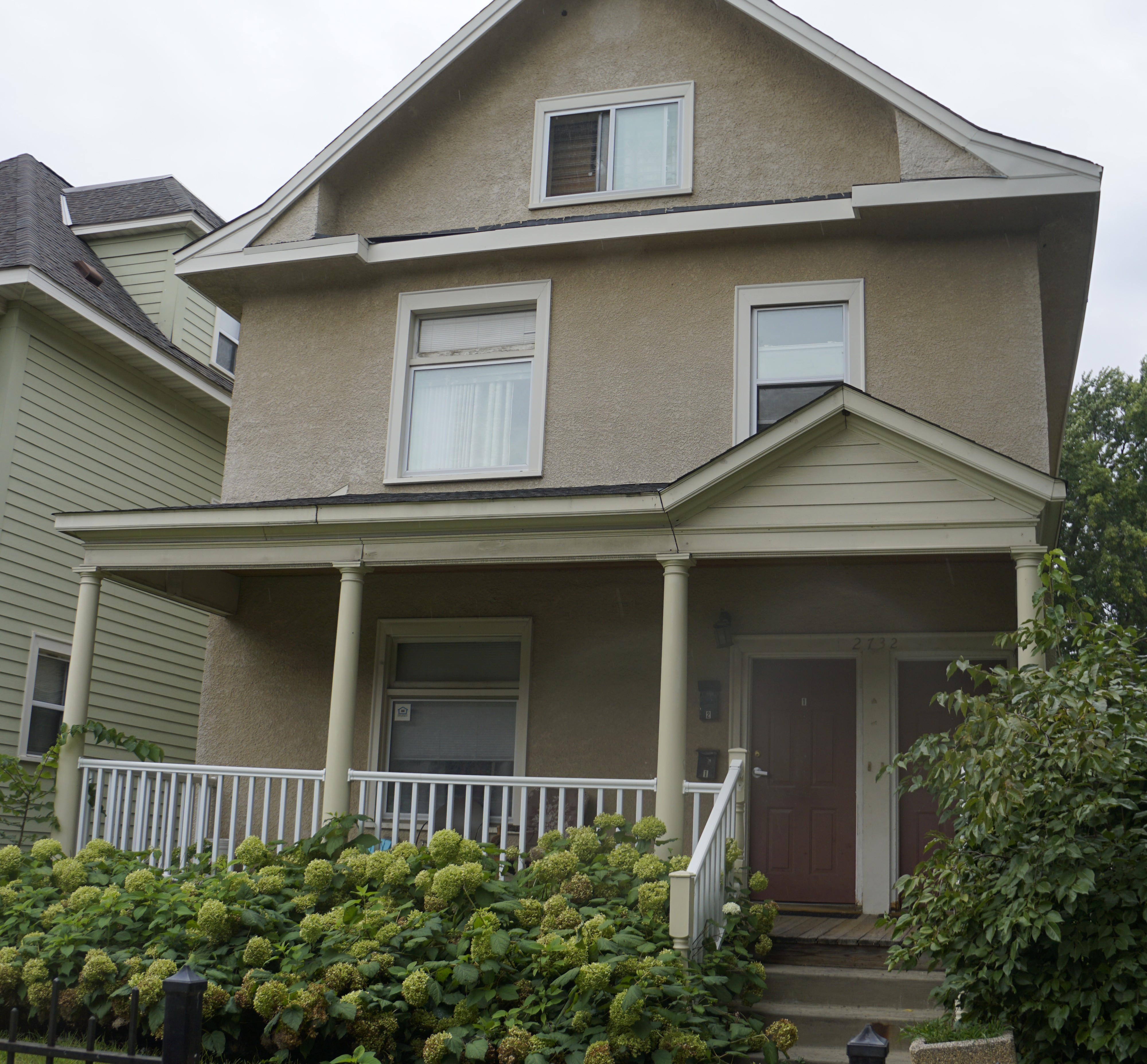 Two story home with tan exterior
