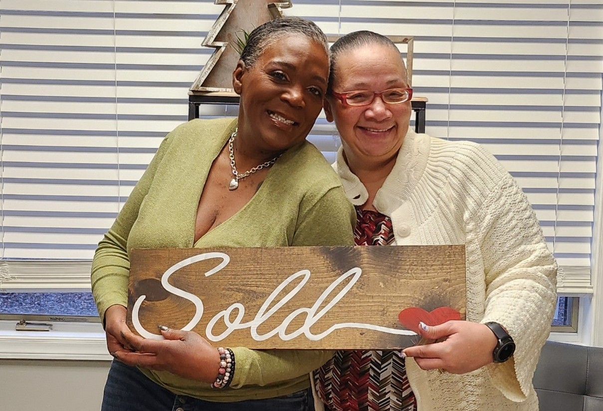 two women smiling after closing on a new home