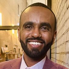 Man standing in suit and smiling