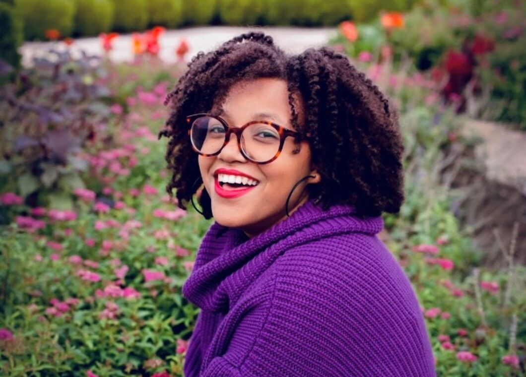 woman smiling in a botanical garden