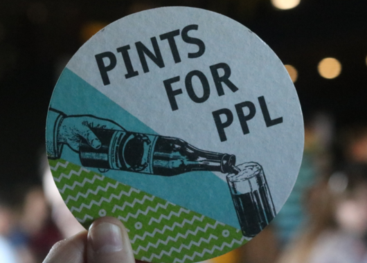 Hand holding a coaster that says Pints for PPL