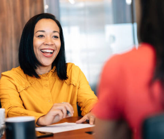 Woman smiling across a desk