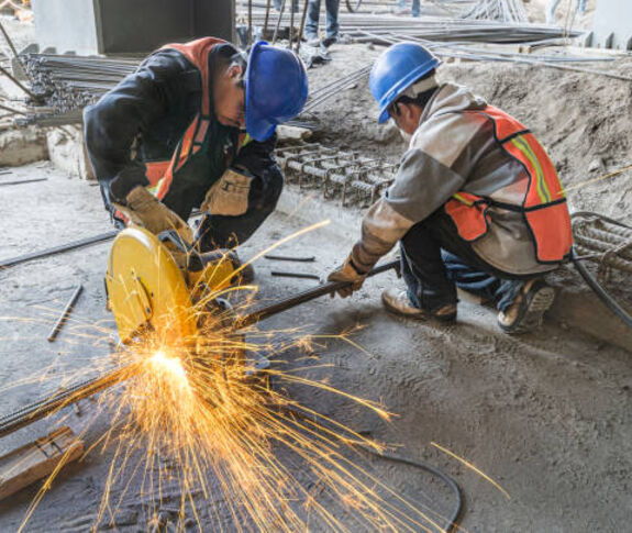 Two construction workers working