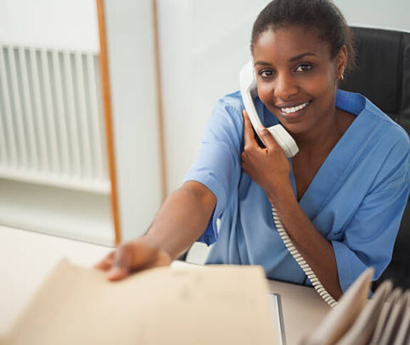 Young female worker on phone smiling