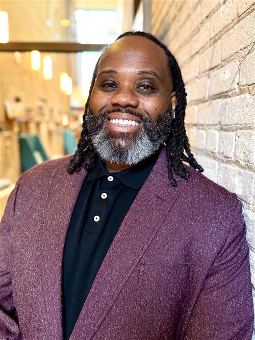 Man in a suit smiling