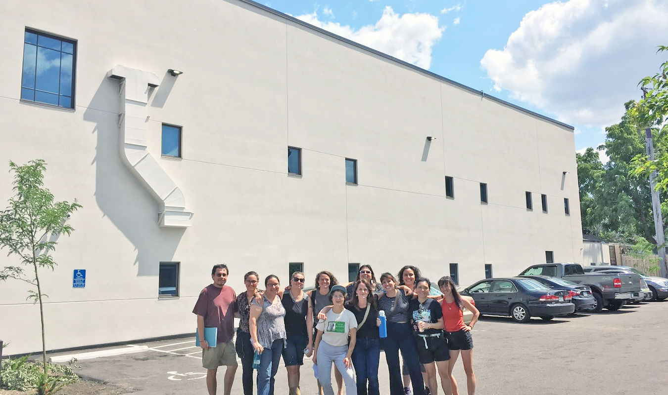 Artist cohort in front of the blank canvas