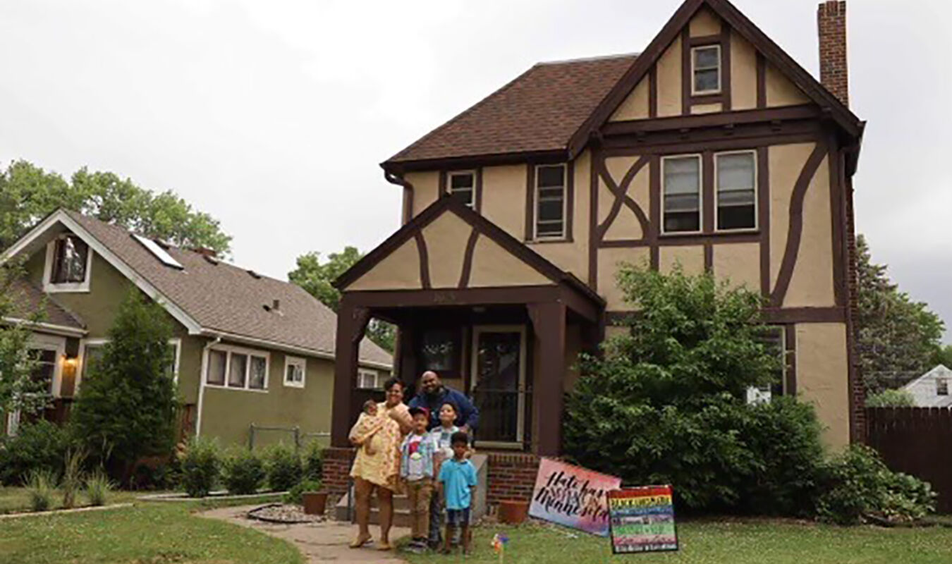 family in front of house