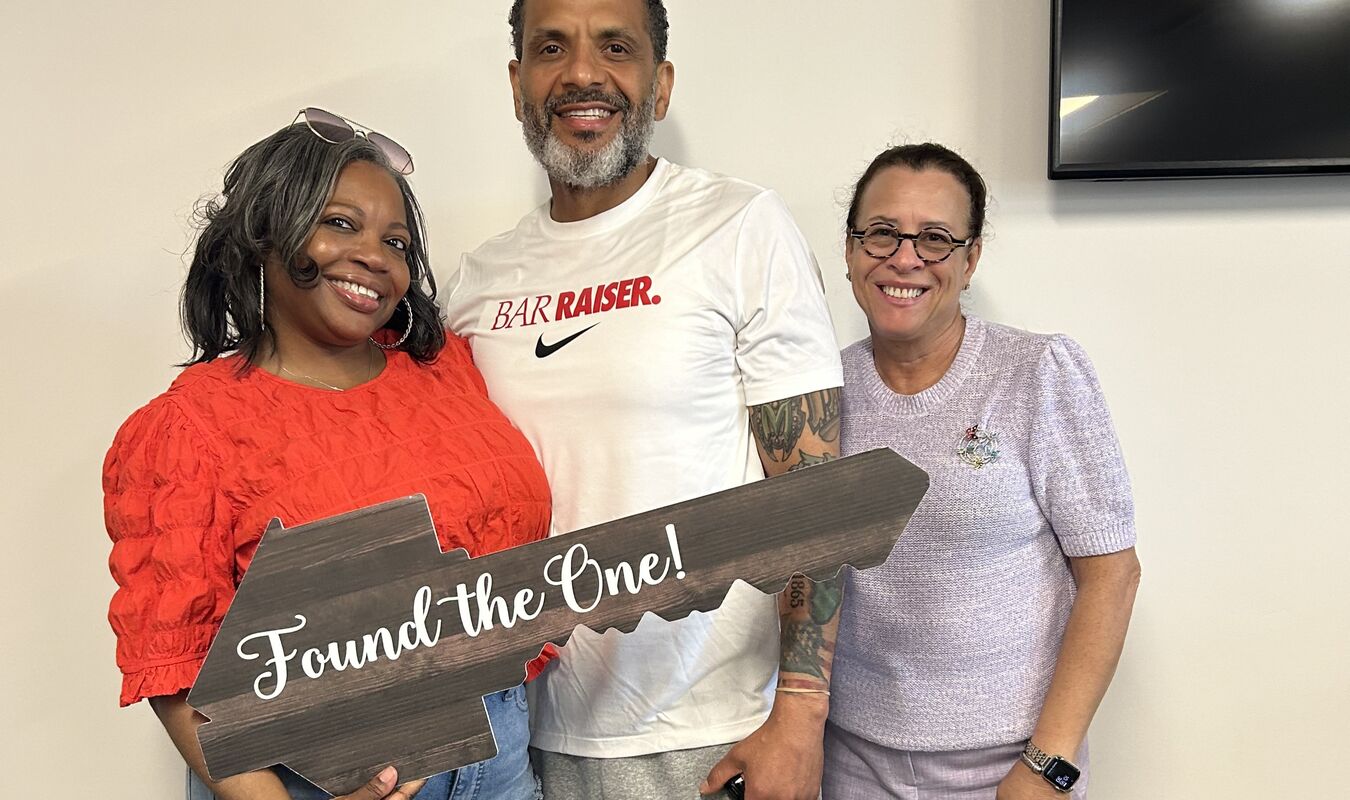 three people smiling after closing on new home property