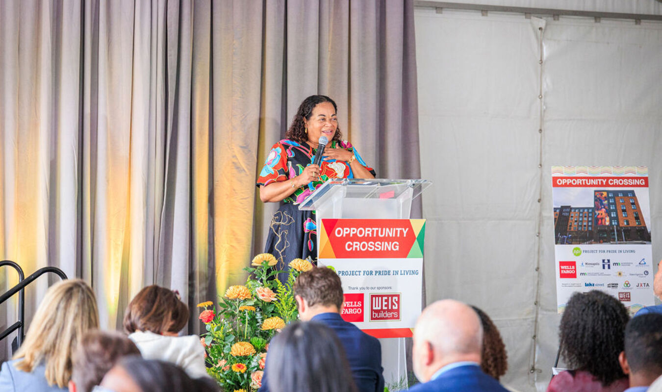 Karla Henderson, president and chief executive officer of Minneapolis-based Project for Pride in Living, speaks during the grand opening of Opportunity Crossing. 