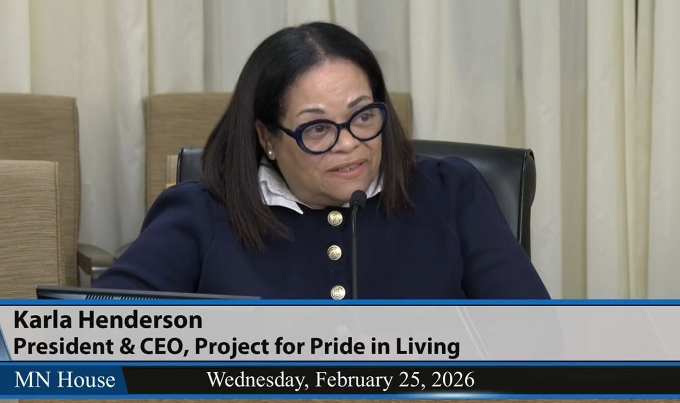 karla henderson sitting at a microphone testifying