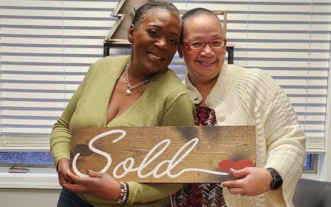 two women smiling after closing on a new home