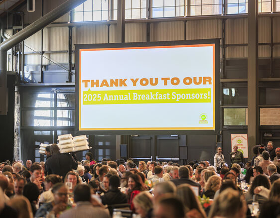 Thank you message to sponsors on a giant screen at breakfast event